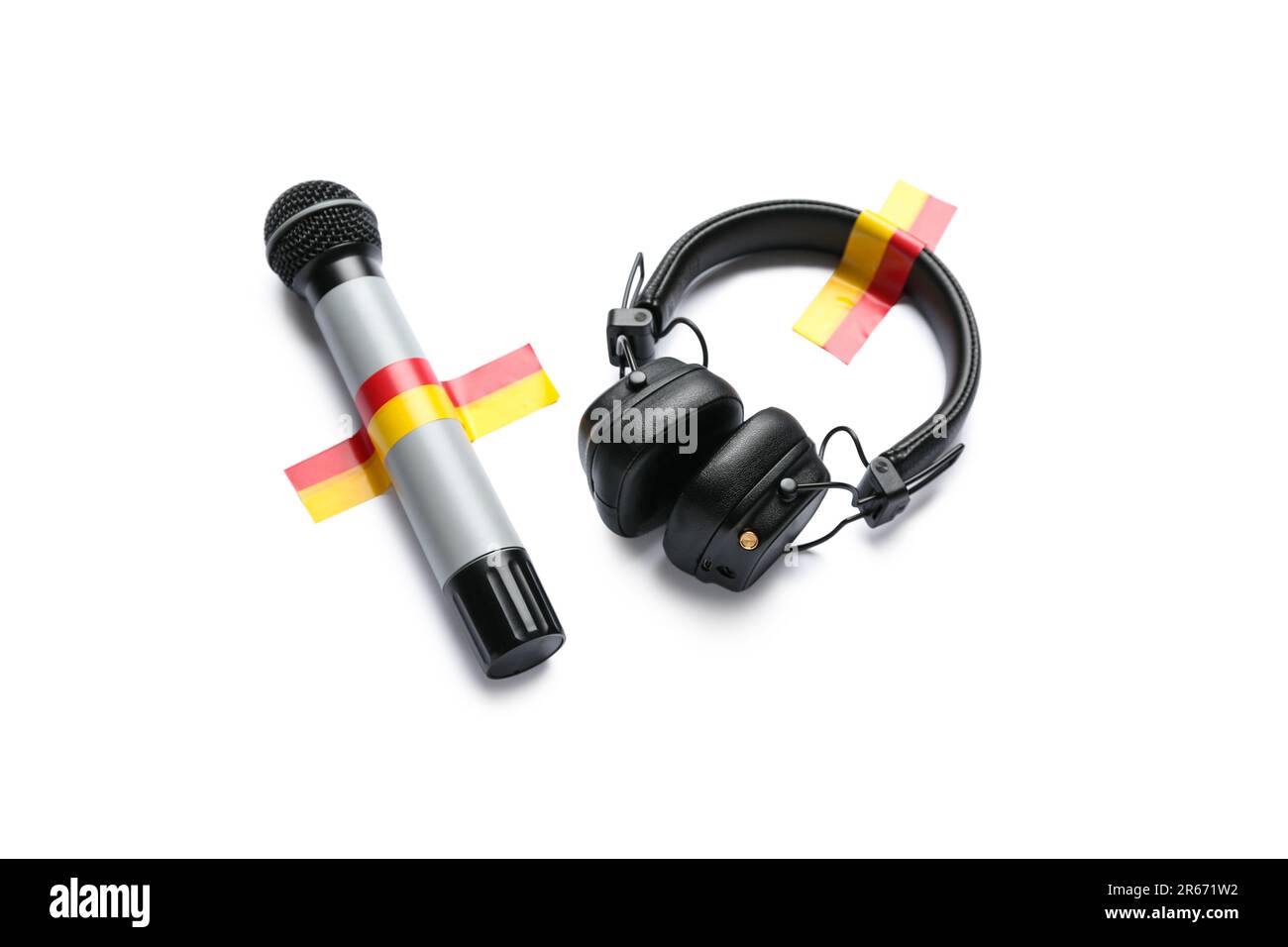 Microphone with headphones and adhesive tapes on white background Stock