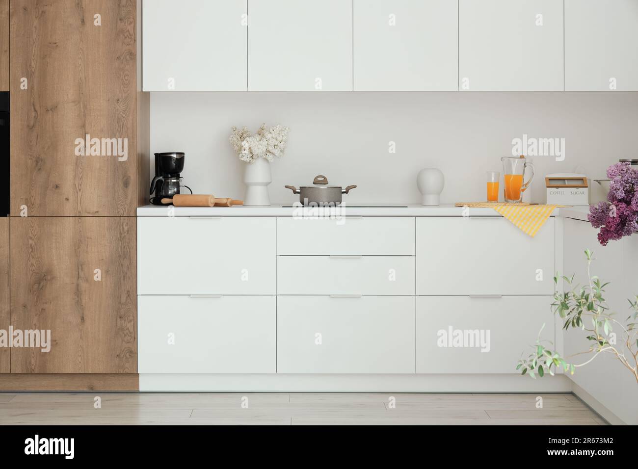 Interior of light kitchen with white counters and flowers Stock Photo ...