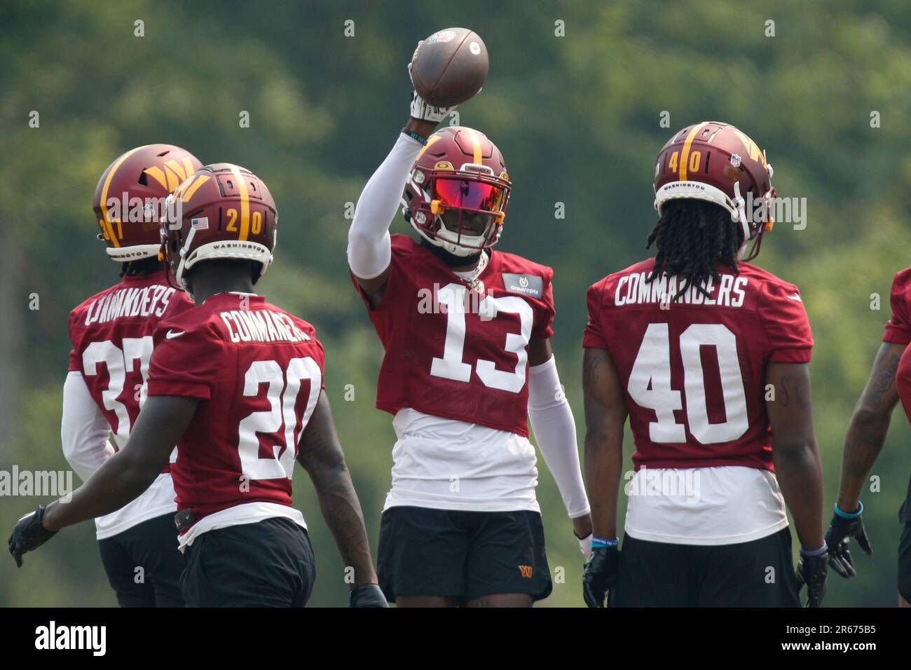 Washington Commanders cornerback Emmanuel Forbes Jr. holds the ball