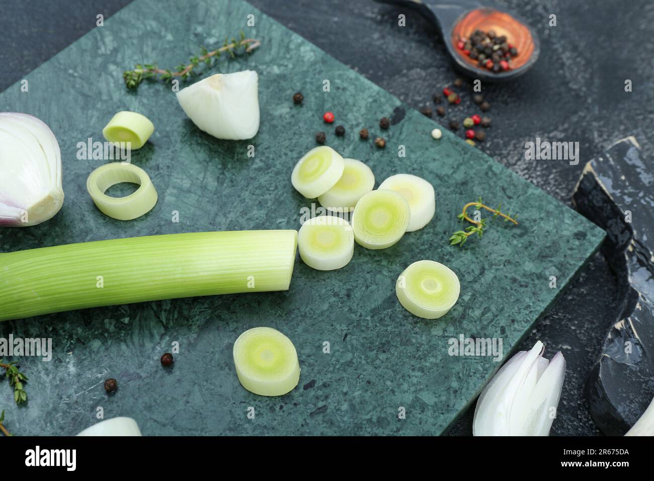 Board with different kinds of onion on grunge black background Stock ...