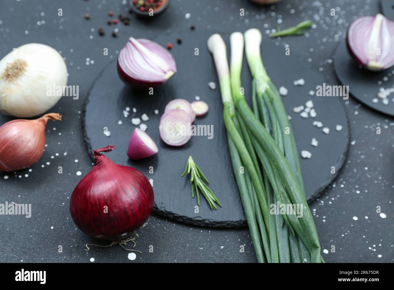 Boards with different kinds of onion on grunge black background Stock ...