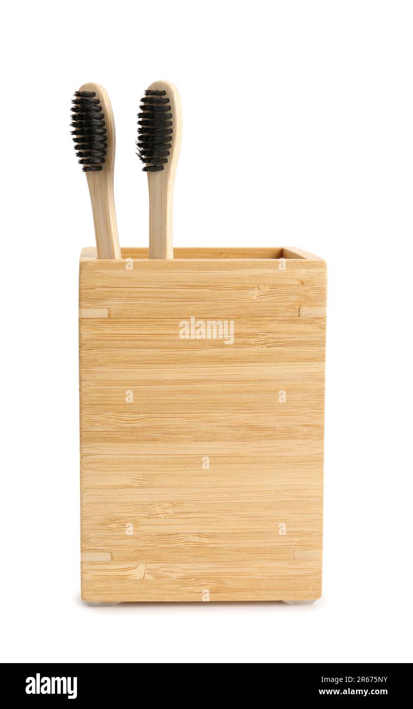 Bamboo tooth brushes in holder on white background Stock Photo - Alamy