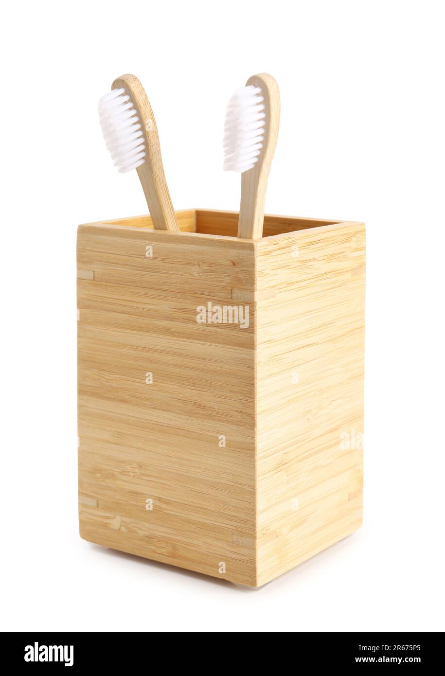 Bamboo tooth brushes in holder on white background Stock Photo - Alamy