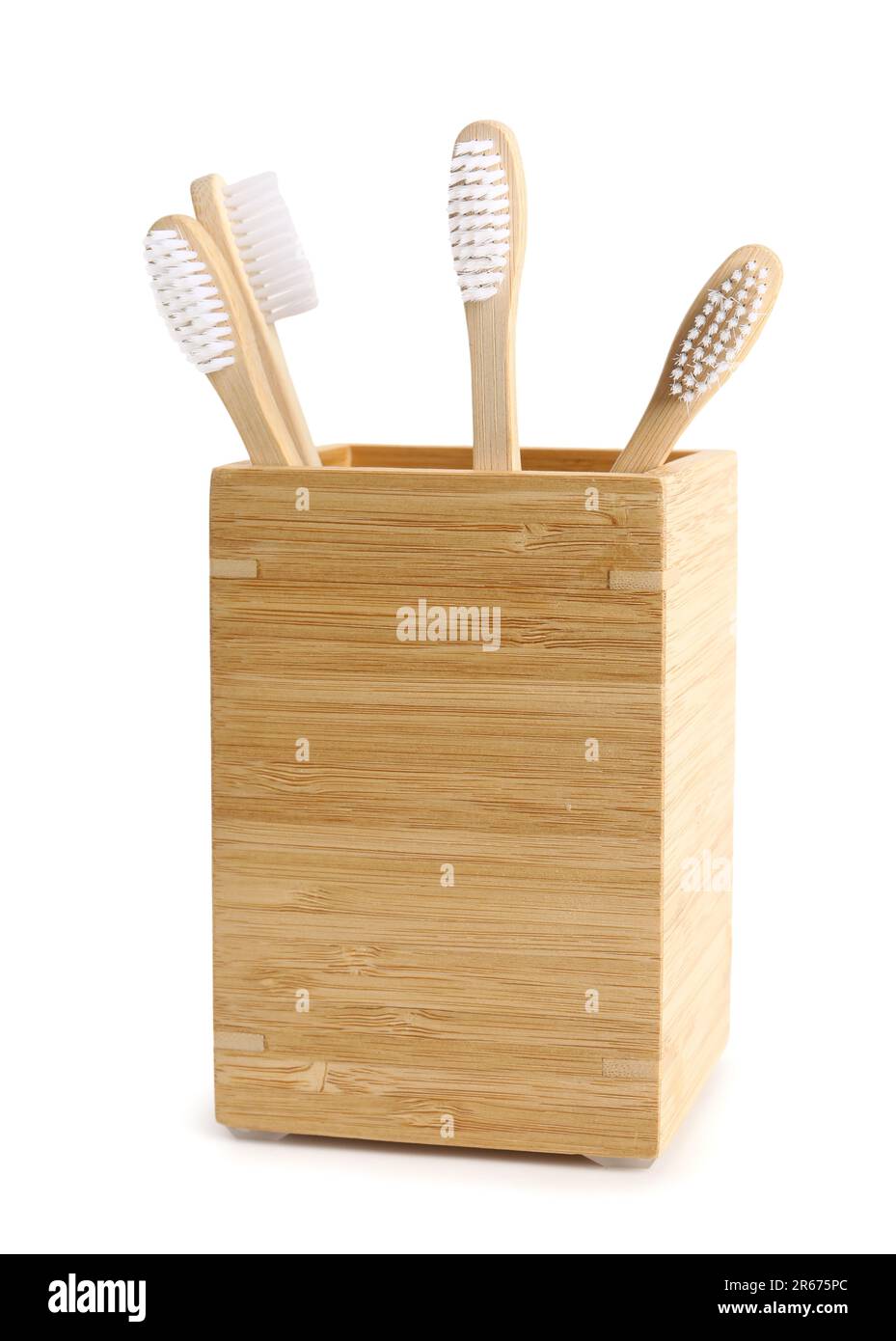 Bamboo tooth brushes in holder on white background Stock Photo - Alamy
