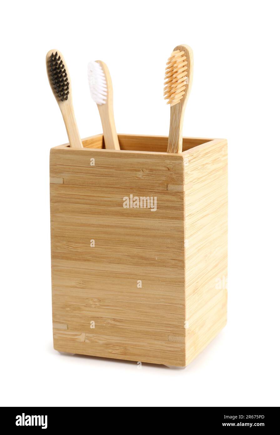 Bamboo tooth brushes in holder on white background Stock Photo - Alamy