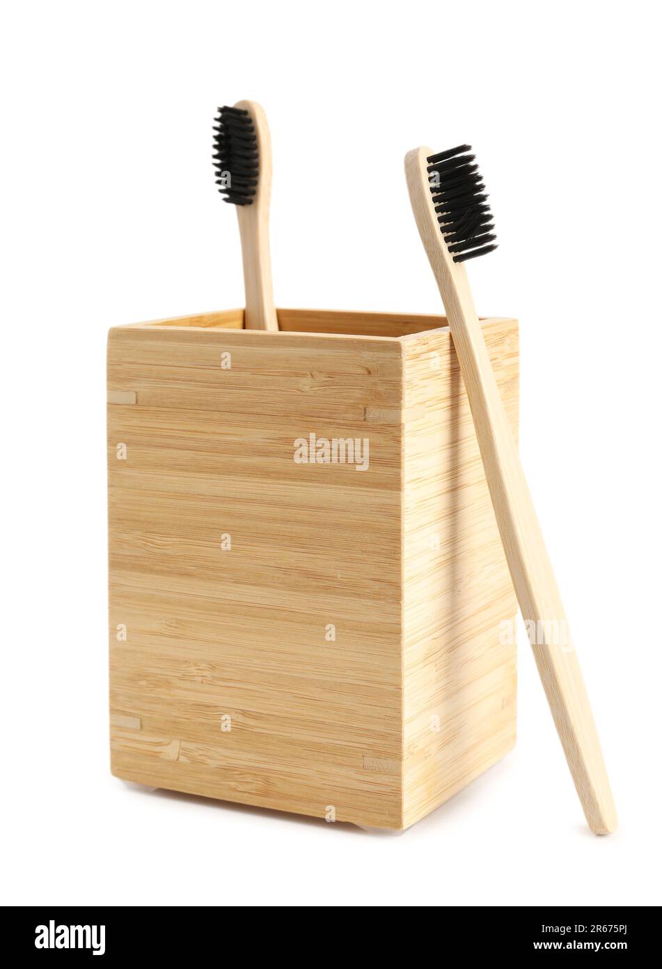 Bamboo tooth brushes and holder on white background Stock Photo - Alamy