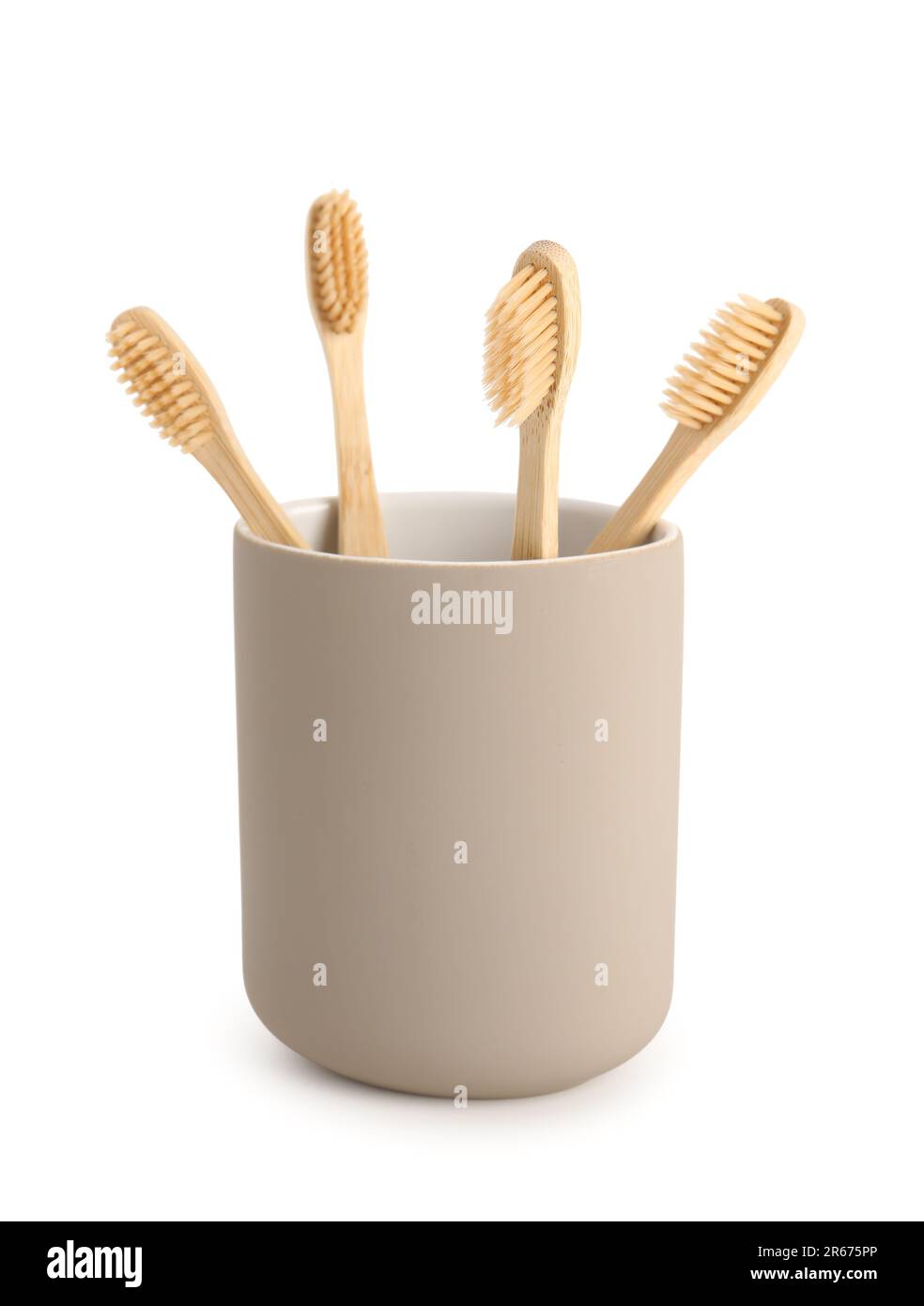 Bamboo tooth brushes in holder on white background Stock Photo - Alamy