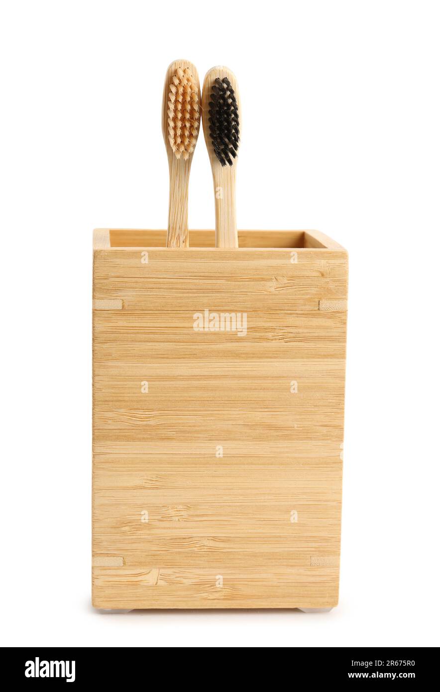 Bamboo tooth brushes in holder on white background Stock Photo - Alamy