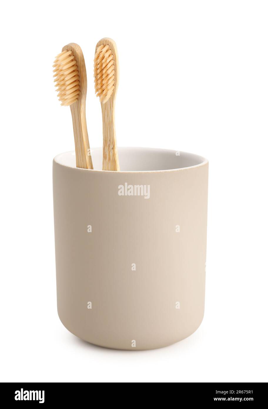 Bamboo tooth brushes in holder on white background Stock Photo - Alamy