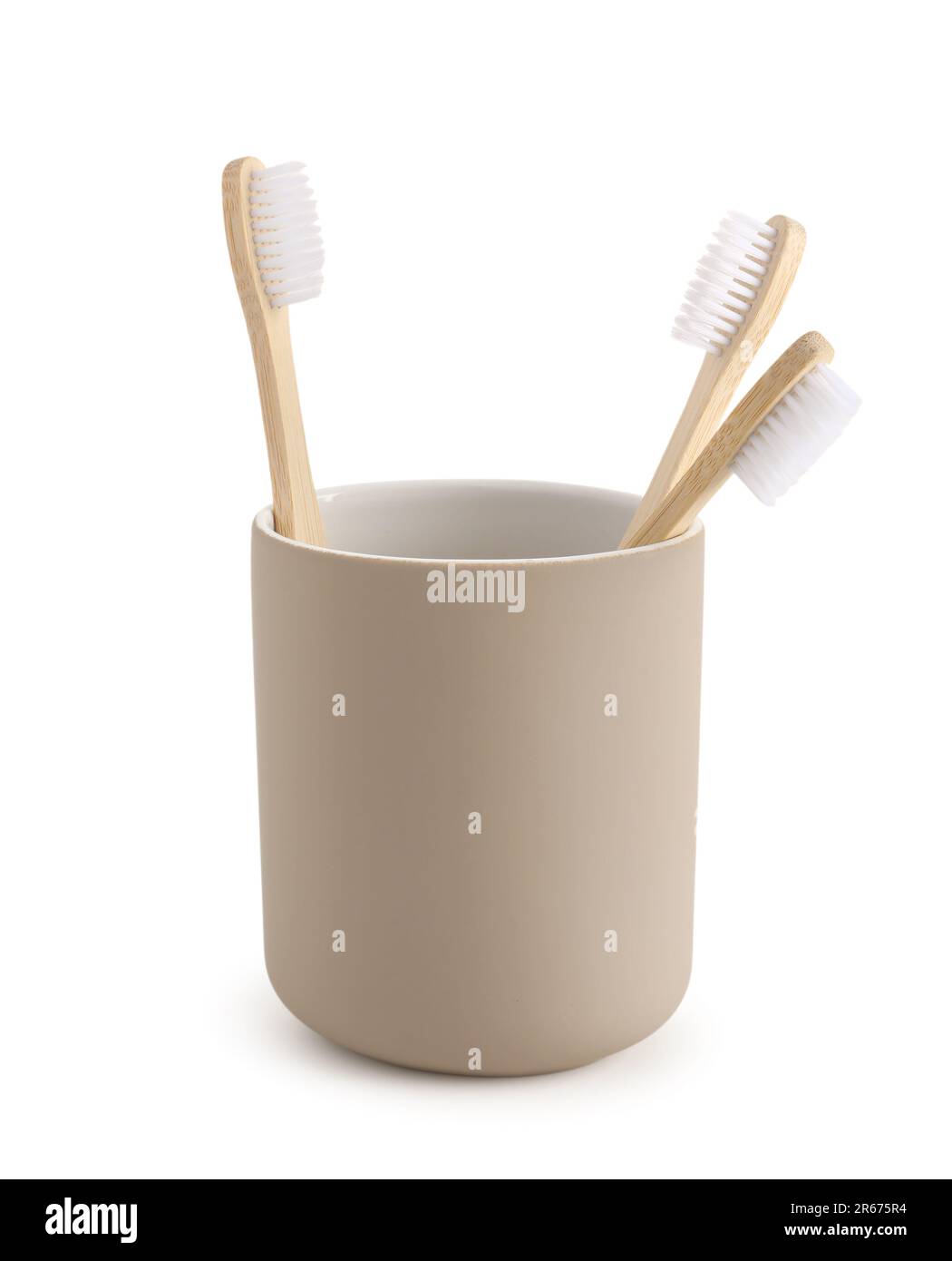 Bamboo tooth brushes in holder on white background Stock Photo - Alamy