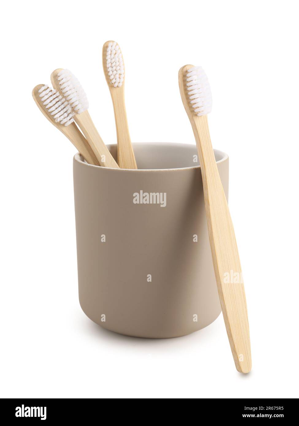 Bamboo tooth brushes in holder on white background Stock Photo - Alamy