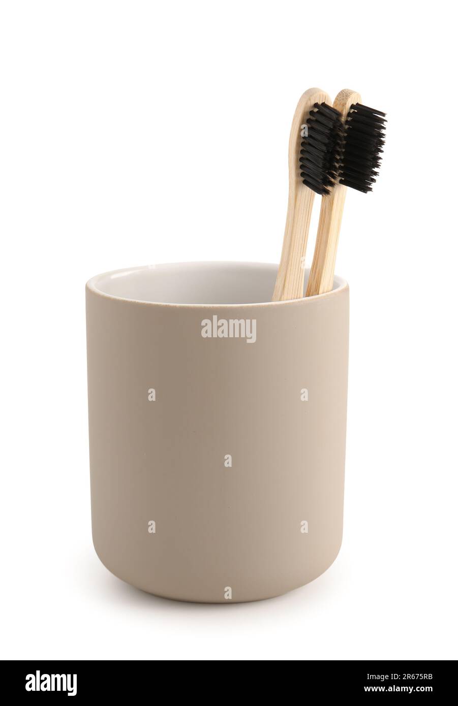 Bamboo tooth brushes in holder on white background Stock Photo - Alamy