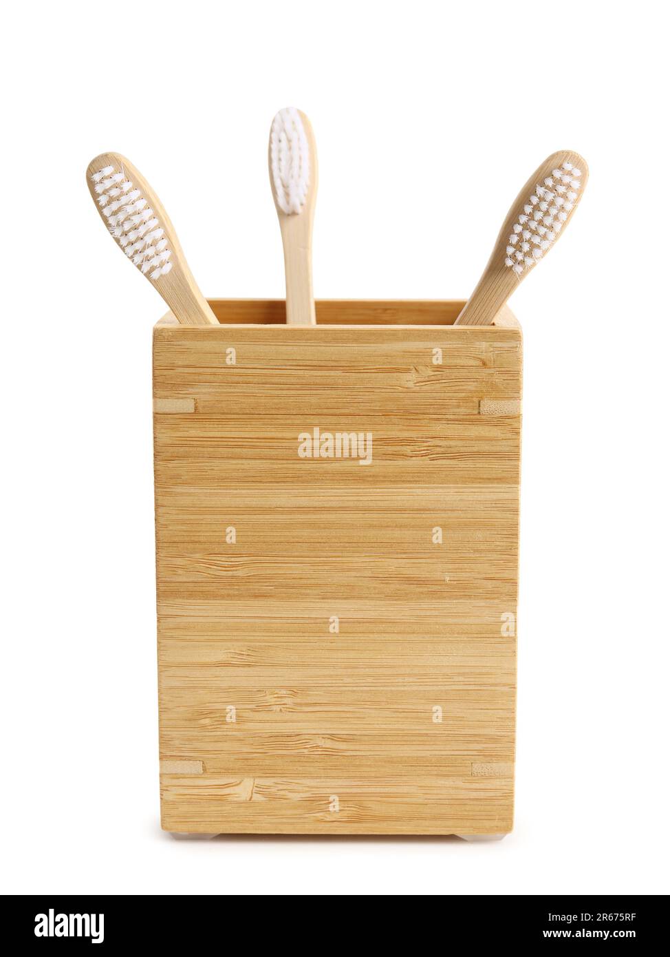 Bamboo tooth brushes in holder on white background Stock Photo - Alamy