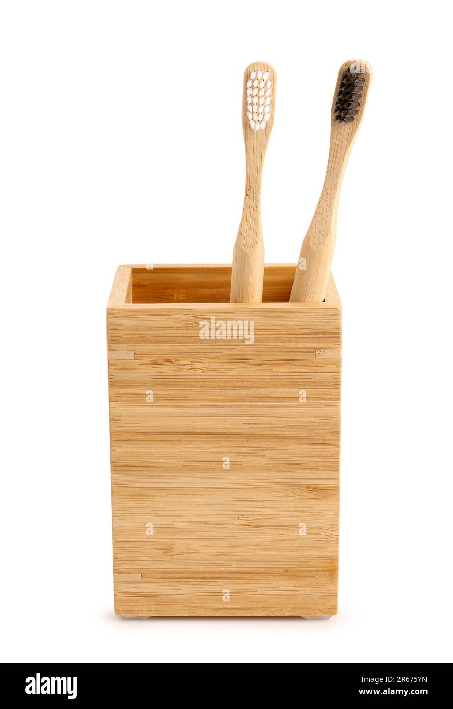 Bamboo tooth brushes in holder on white background Stock Photo - Alamy