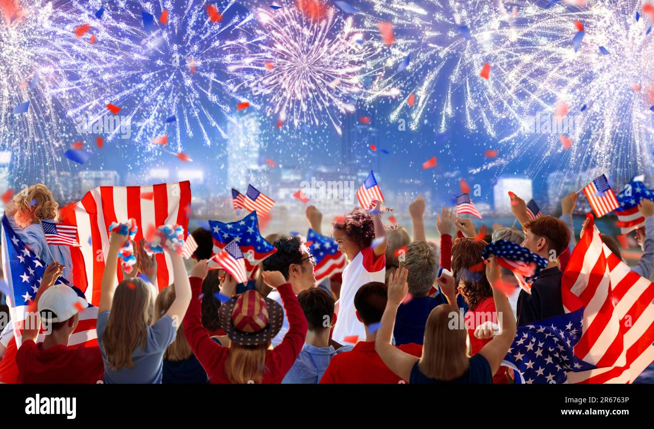 American family celebrating 4th of July. People watching Independence Day fireworks holding US flag. Proud USA crowd cheer and celebrate. Stock Photo