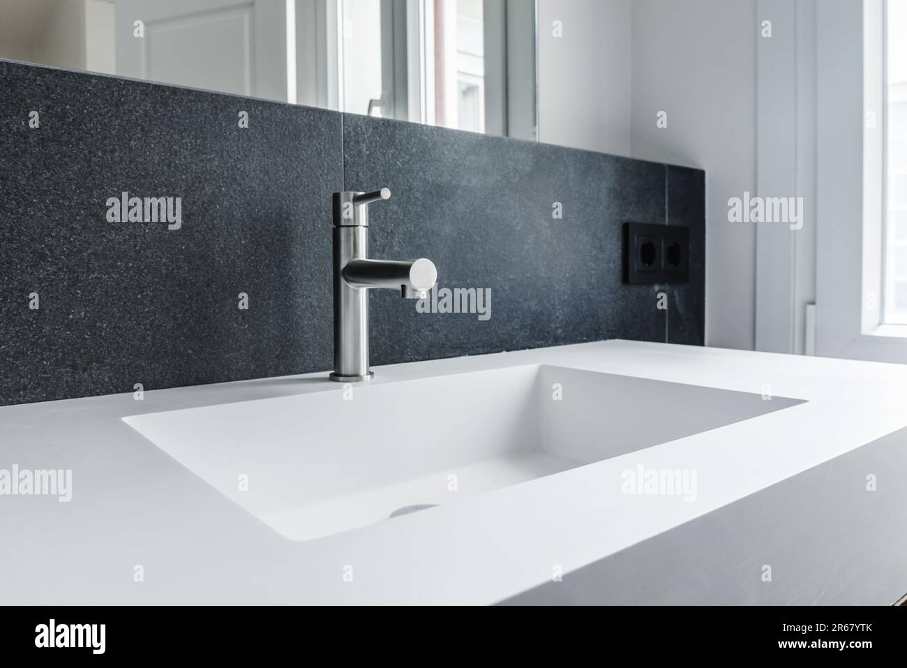 Onepiece porcelain sink with stainless steel faucet and green granite