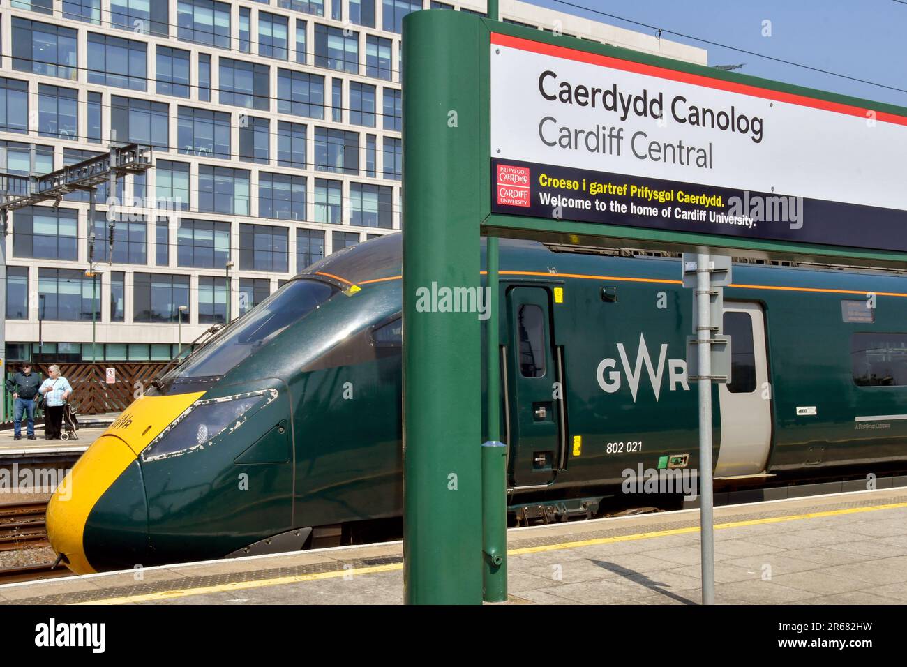 Cardiff, Wales - June 2023: High speed train operated by Great Western Railway alongside a name sign at Cardiff Central railway station Stock Photo