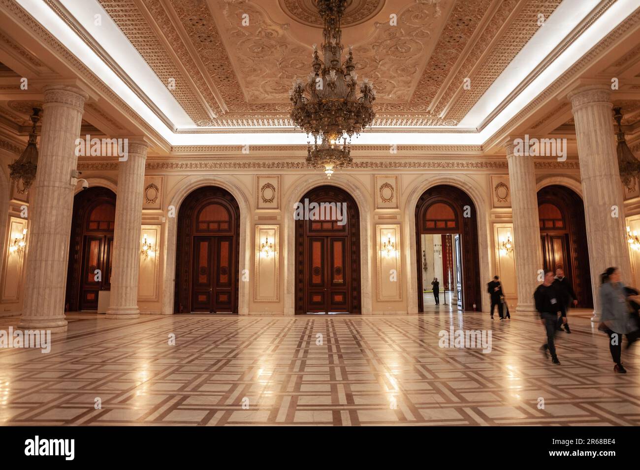 Picture of the interior of the Romanian palace of parliament, with a focus on large wooden doors on a reception hall. The Palace of the Parliament, al Stock Photo