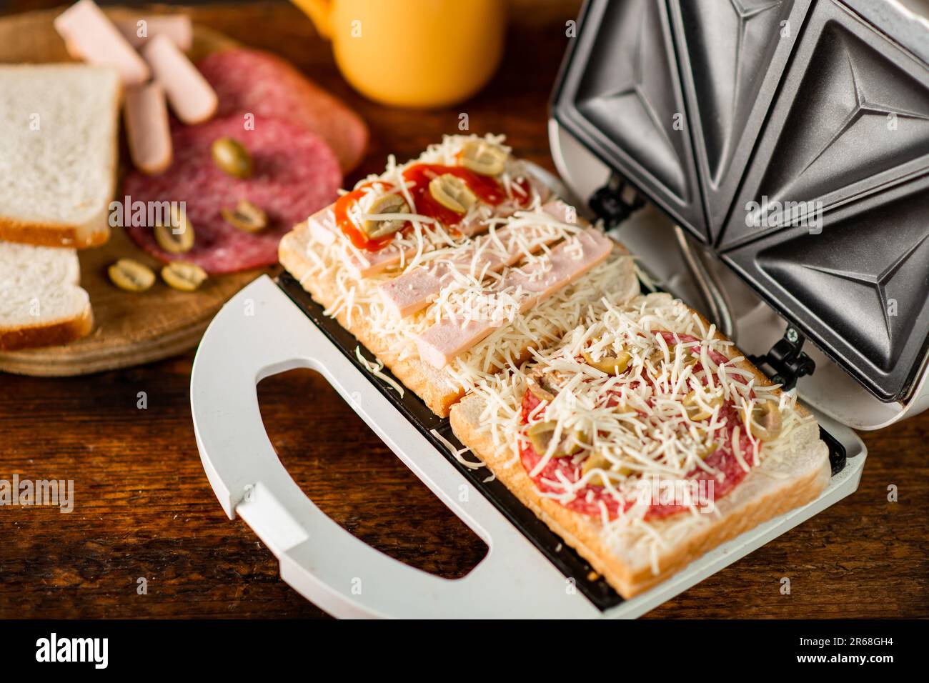 open sandwich maker with cheese toast and sausages. Sandwiching Stock Photo Alamy
