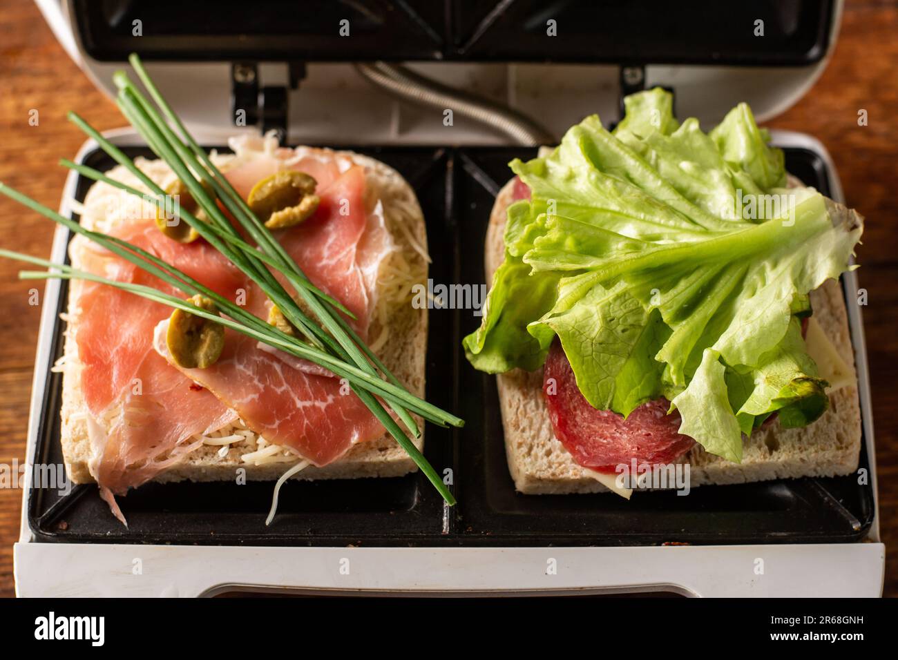 Making sandwiches from ham, vegetables and cheese in a sandwich maker