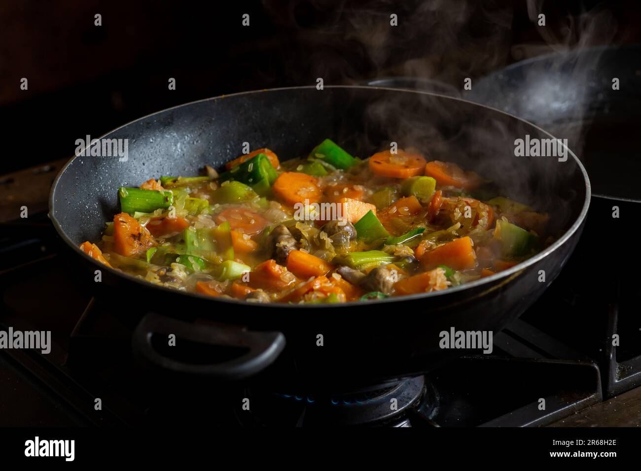 Cooking vegan vegetable stew. Rice with different vegetables leek