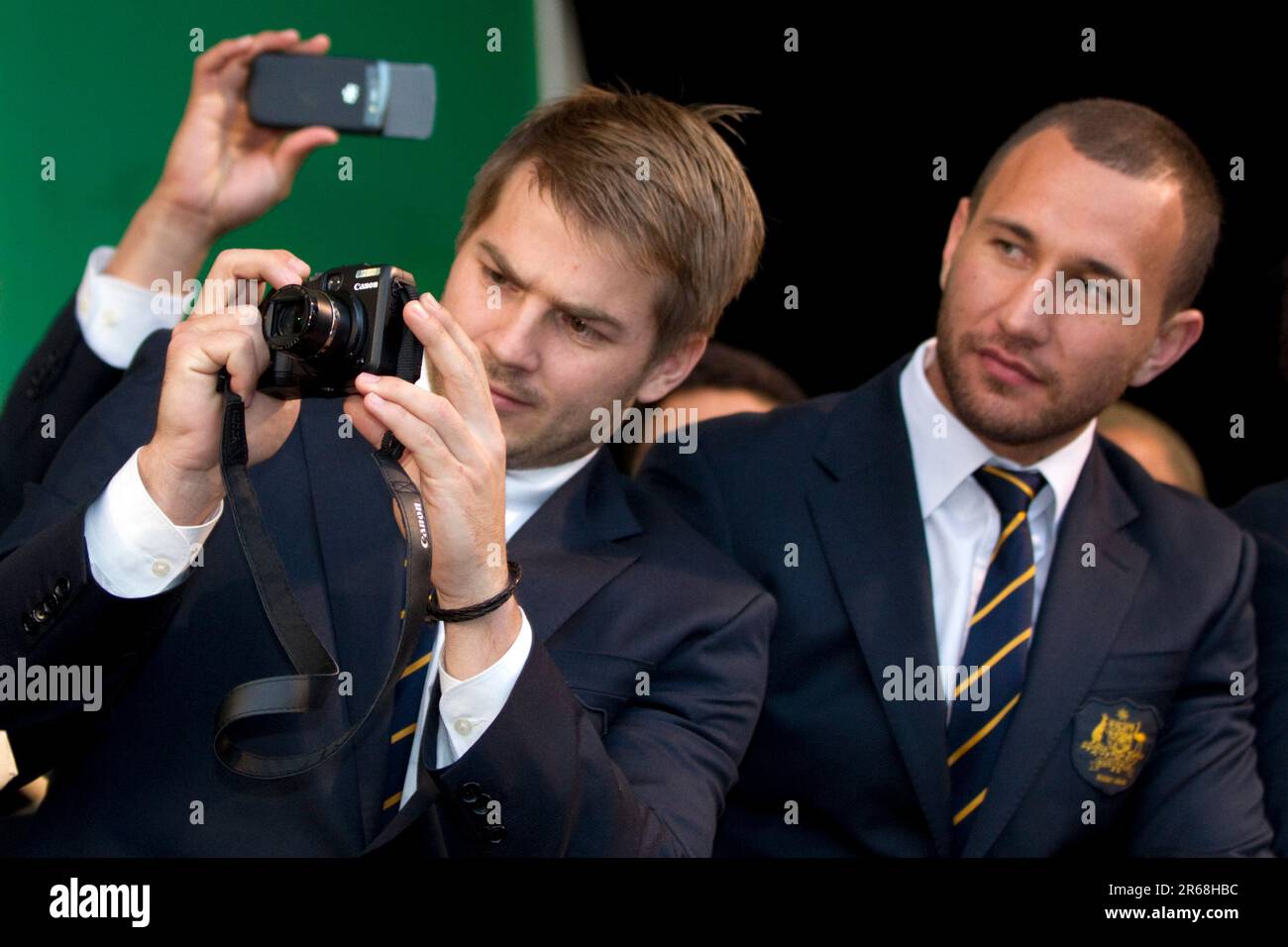 Drew Mitchell takes a photograph watched by Quade Cooper Australia's Rugby World Cup Team arrive for the official welcome, Aotea Square, Auckland, New Zealand, Tuesday, September 06, 2011. Stock Photo