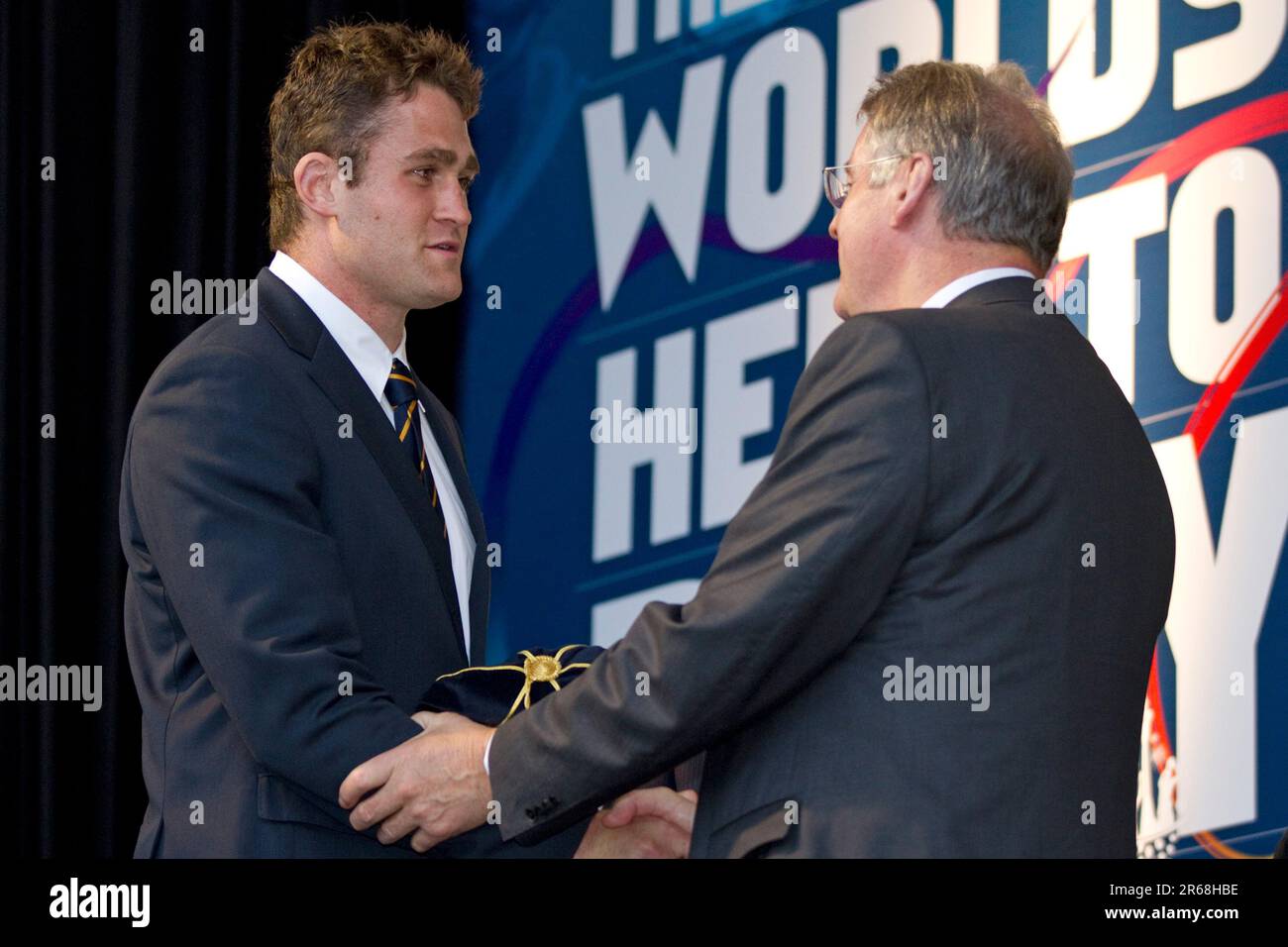 Team Captain James Horwill receives his tournament cap from IRB Chairman Bernard Lapasset at Australia's Rugby World Cup Team official welcome, Aotea Square, Auckland, New Zealand, Tuesday, September 06, 2011. Stock Photo