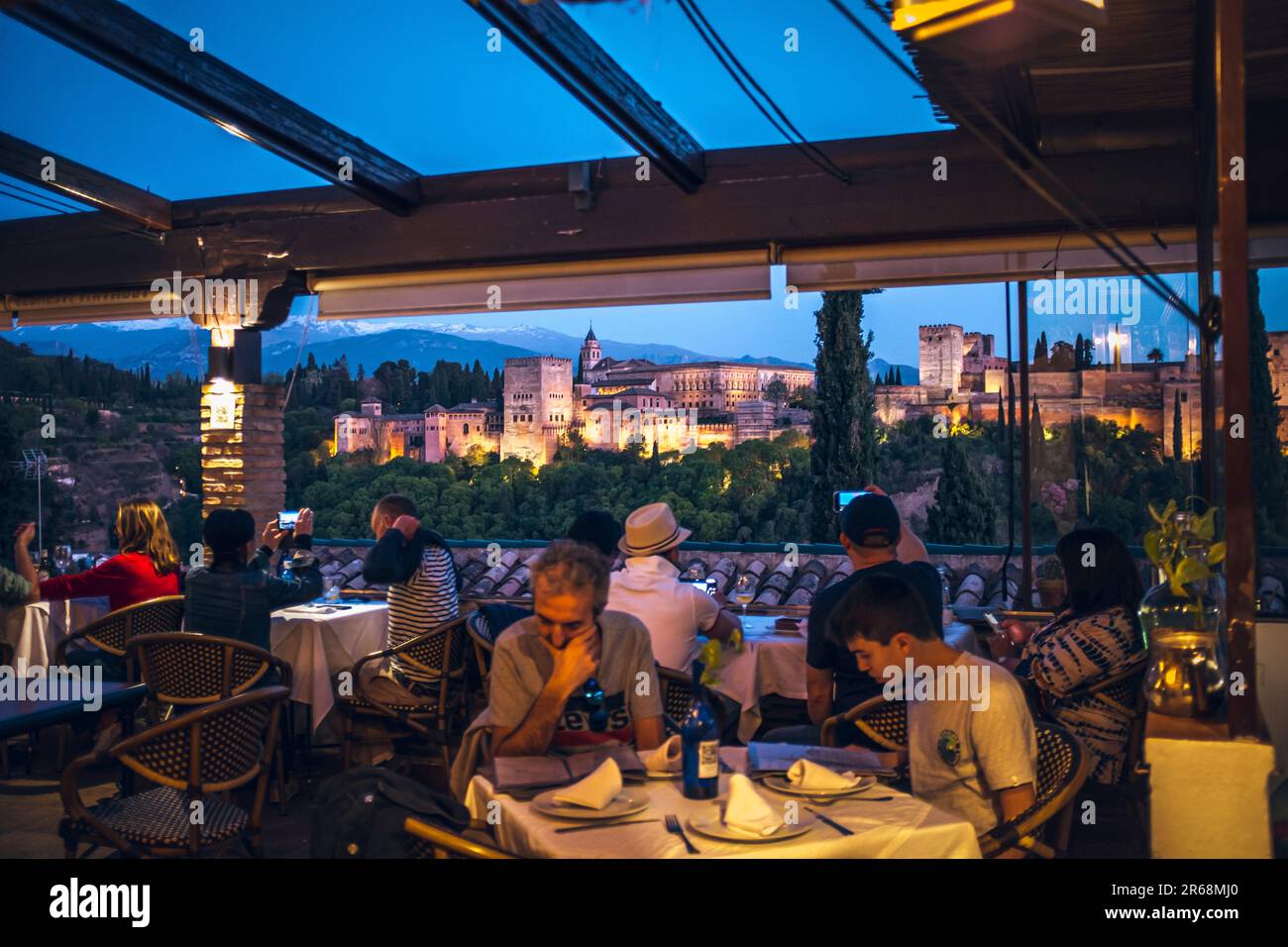 Photograph of the Alhambra at night illuminated from a bar Stock Photo