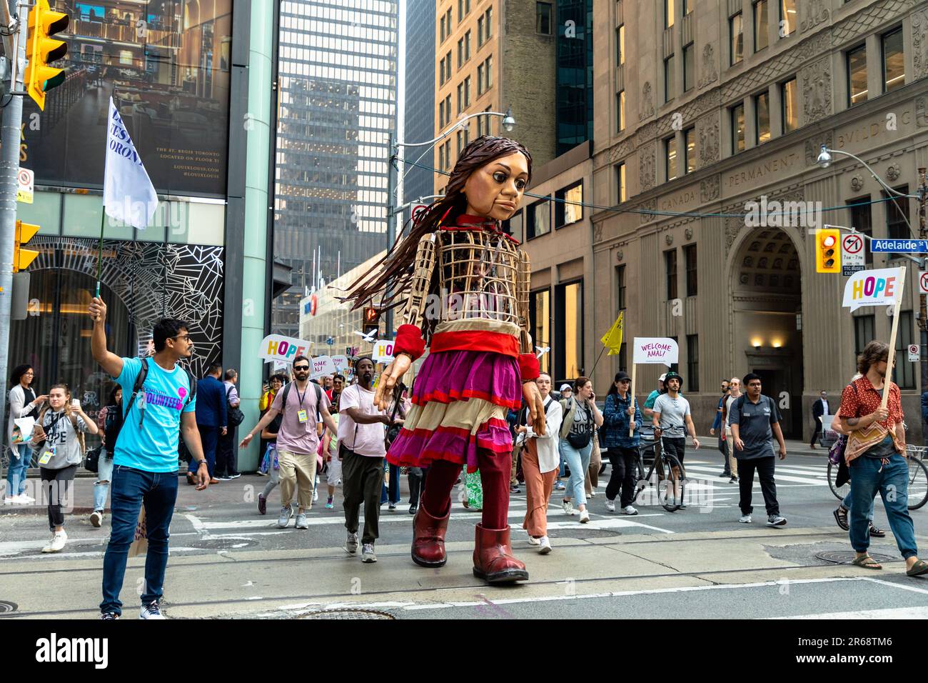 Toronto, Canada - June 07 2023: Hundreds of Indigenous people, social-justice activists and supporters welcomed 'Little Amal.' The 3.6-metre (12-foot) puppet, symbolizing a 10-year-old Syrian refugee, led a peaceful march through downtown Toronto  as part of a global campaign Stock Photo