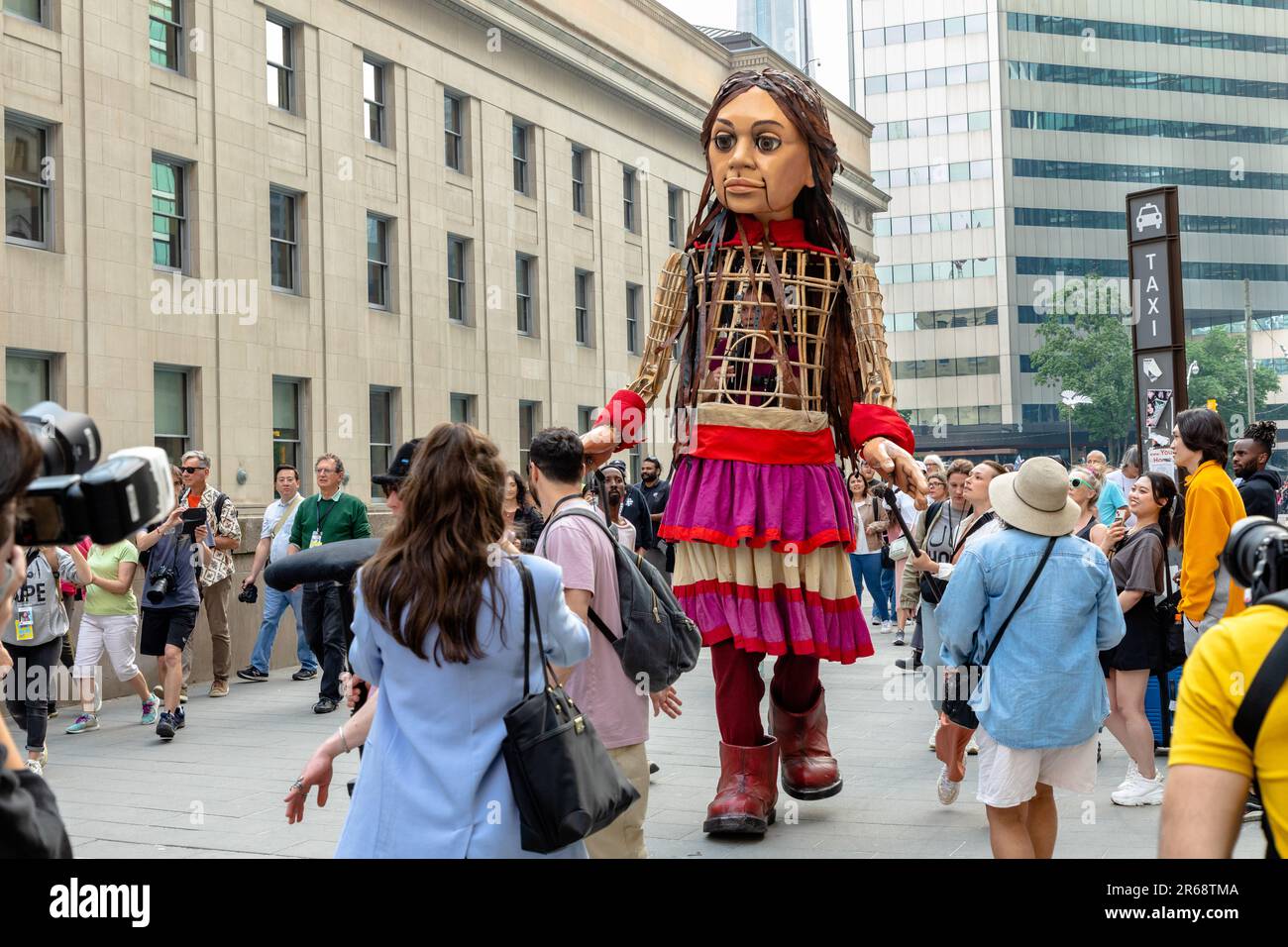 Toronto, Canada - June 07 2023: Hundreds of Indigenous people, social-justice activists and supporters welcomed 'Little Amal.' The 3.6-metre (12-foot) puppet, symbolizing a 10-year-old Syrian refugee, led a peaceful march through downtown Toronto  as part of a global campaign Stock Photo