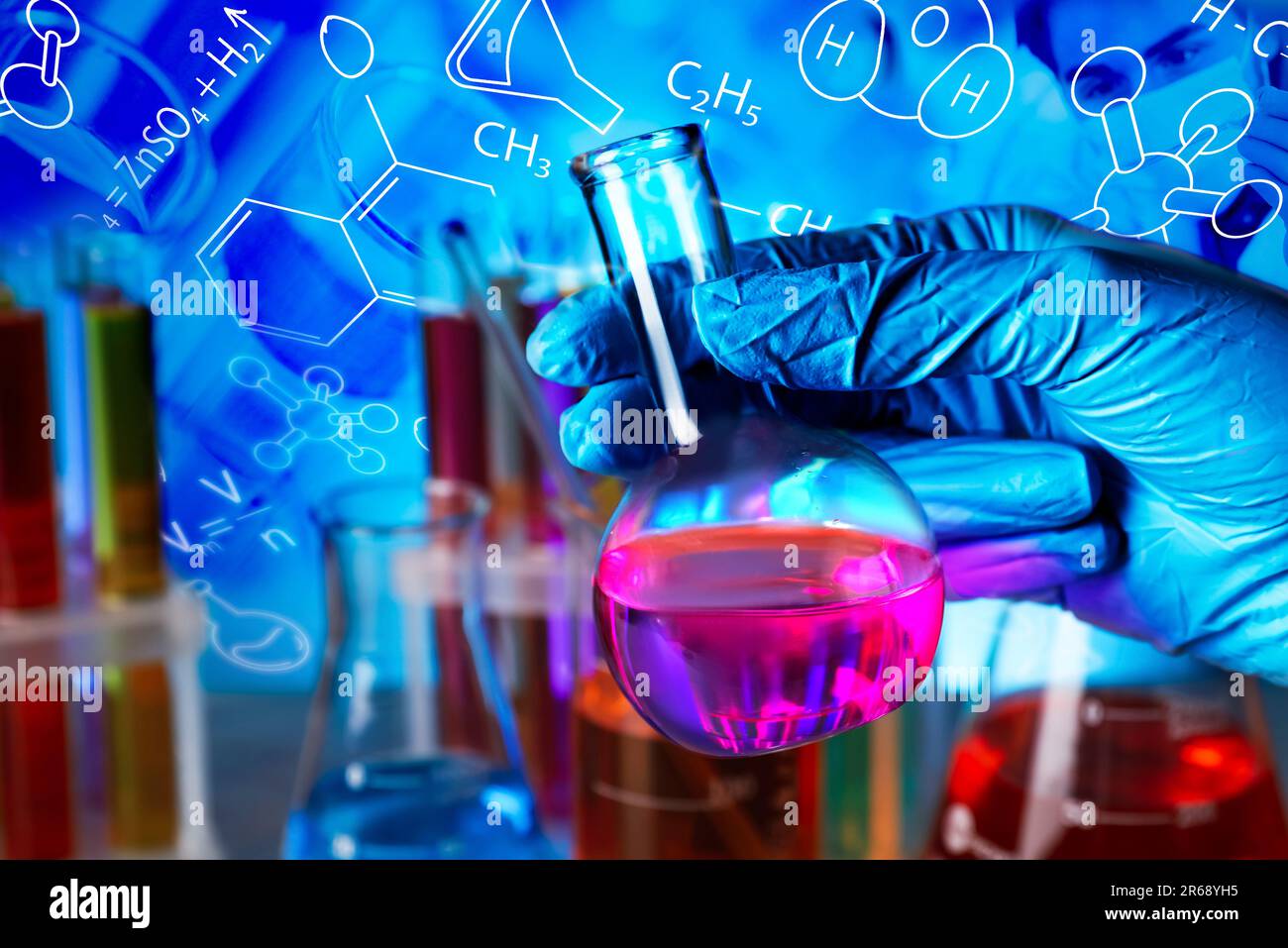 Scientist holding flask, test tubes and different chemical formulas