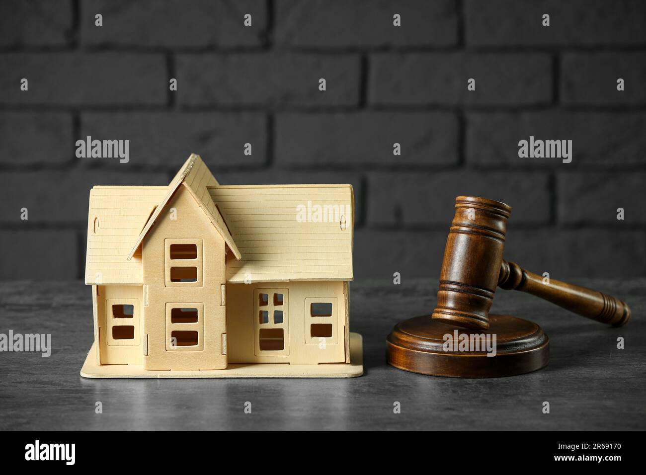 Construction and land law concepts. Judge gavel with house model on grey table Stock Photo
