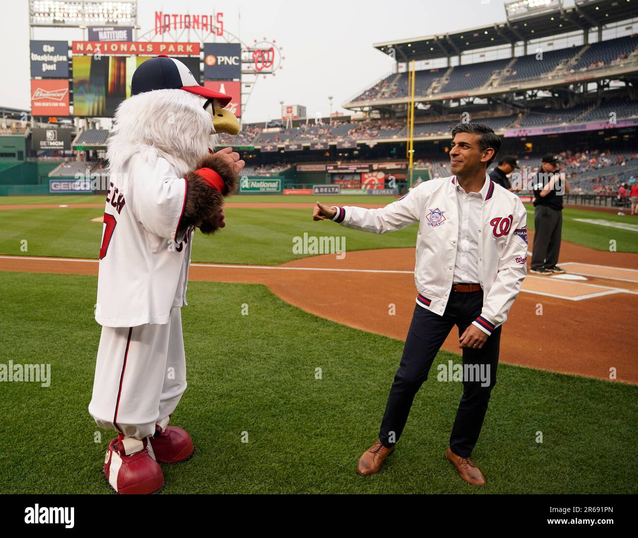 British Prime Minister Rishi Sunak poses with Washington Nationals mascot  Screech as he attends a Washington Nationals baseball game during his  visit to Washington, Wednesday, June 7, 2023. (Kevin Lamarque/Pool Photo via