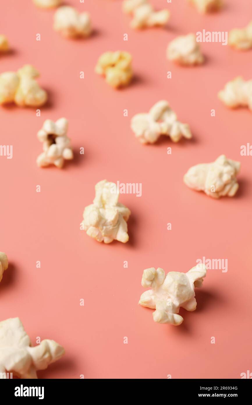 Crispy popcorn on pink background Stock Photo