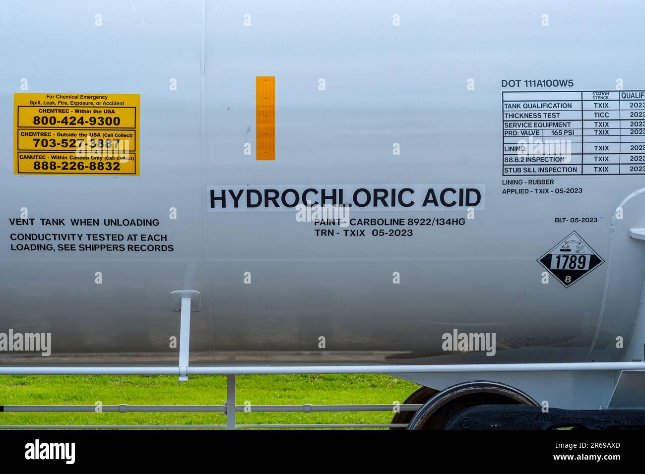 NEW ORLEANS, LA, USA - JUNE 5, 2023: Exterior of railway tank car containing hydrochloric acid with emergency information and warning sign Stock Photo