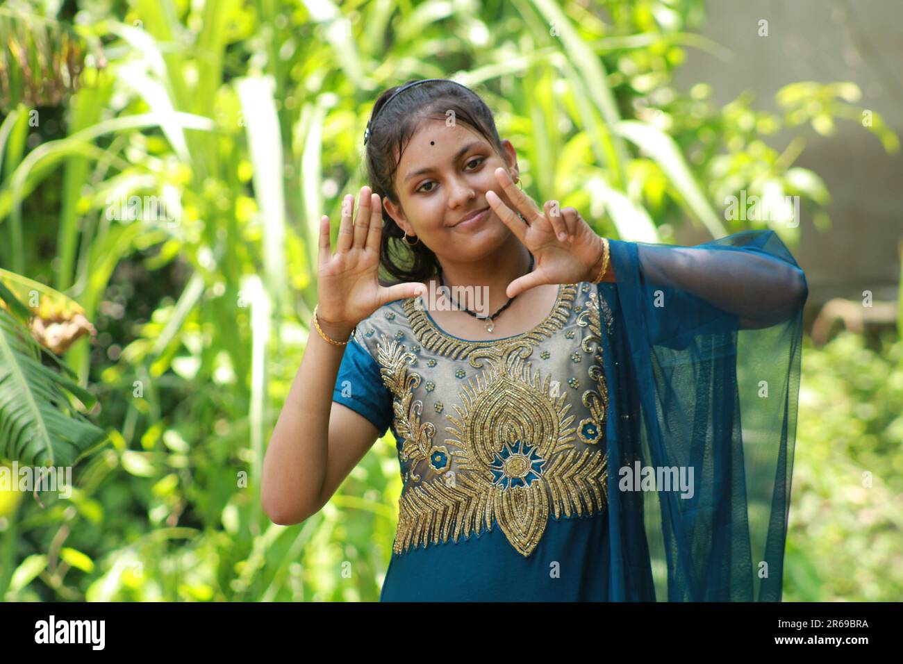 Indian Teenage Girl showing and pointing with finger number eight while smiling confident and happy. Stock Photo