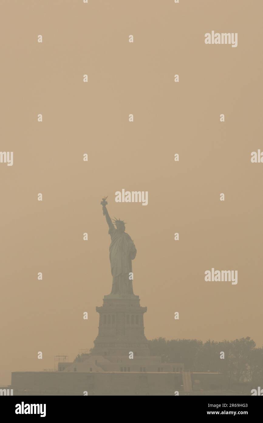 New York City, NY, USA. 7th June, 2023. The Statue of Liberty shrouded in smoke from Canada wildfires in New York, US, on Wednesday, June 7, 2023. The US Northeast, including New York City, will continue to breathe in choking smoke from fires across eastern Canada for the next few days, raising health alarms across impacted areas. (Credit Image: © William Volcov/ZUMA Press Wire) EDITORIAL USAGE ONLY! Not for Commercial USAGE! Stock Photo