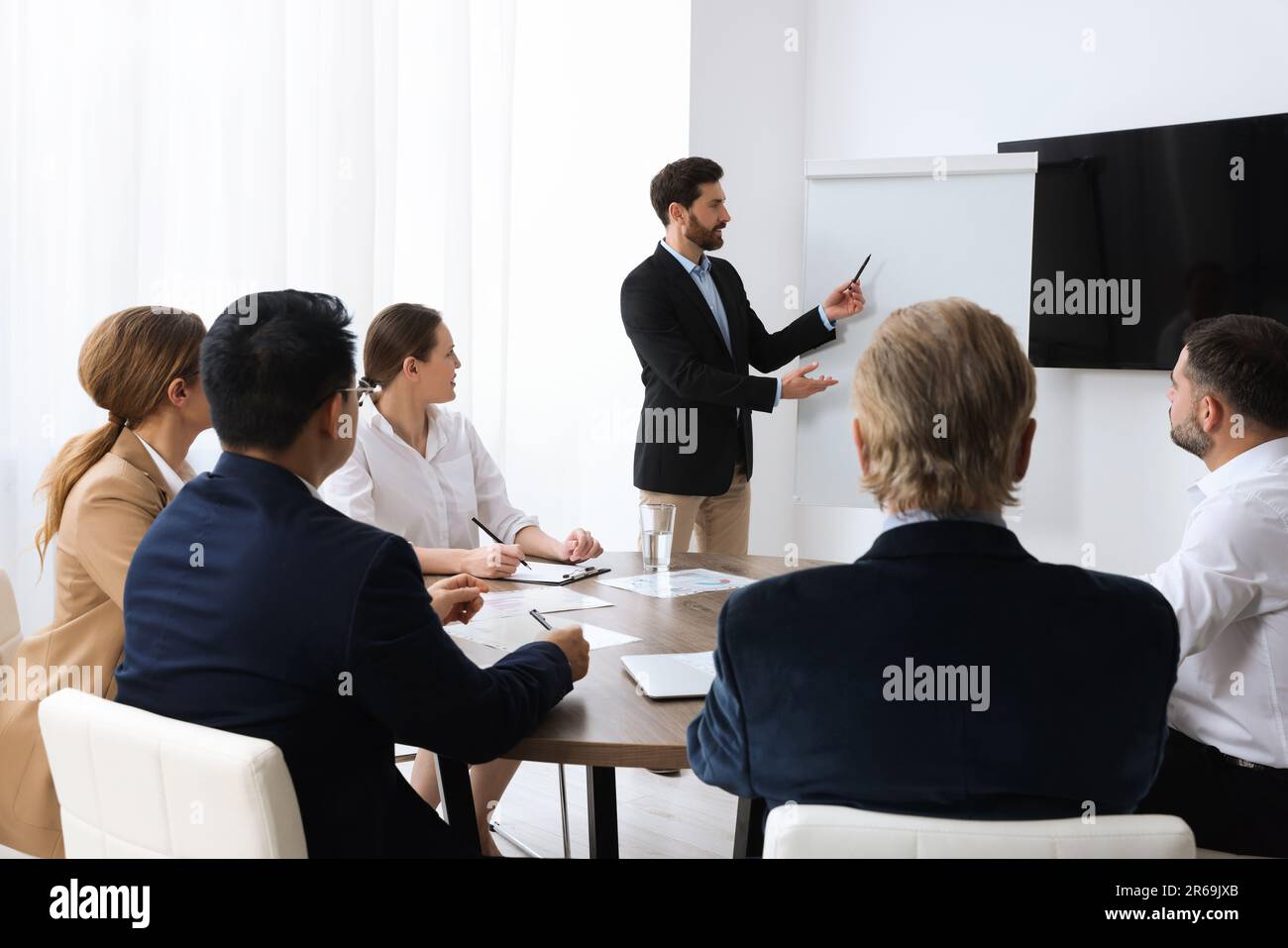 Business conference. Group of people listening to speaker report near ...