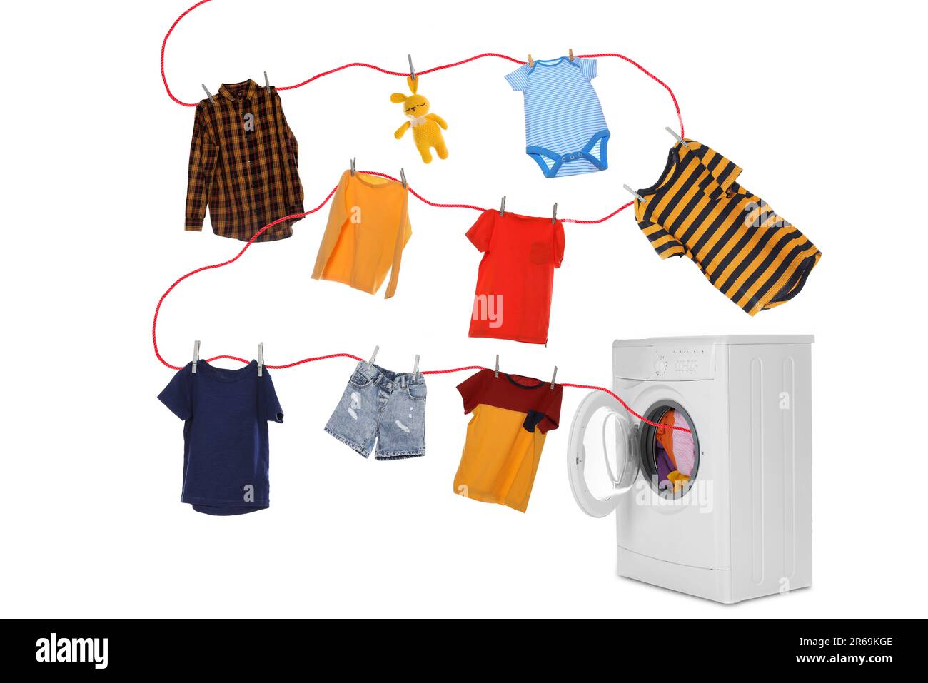 Drying laundry. Rope with children clothes flying out from washing machine on white background Stock Photo