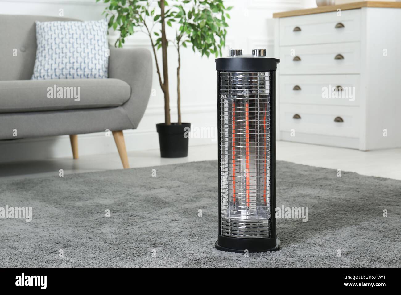 Modern infrared heater on carpet in cozy room Stock Photo Alamy