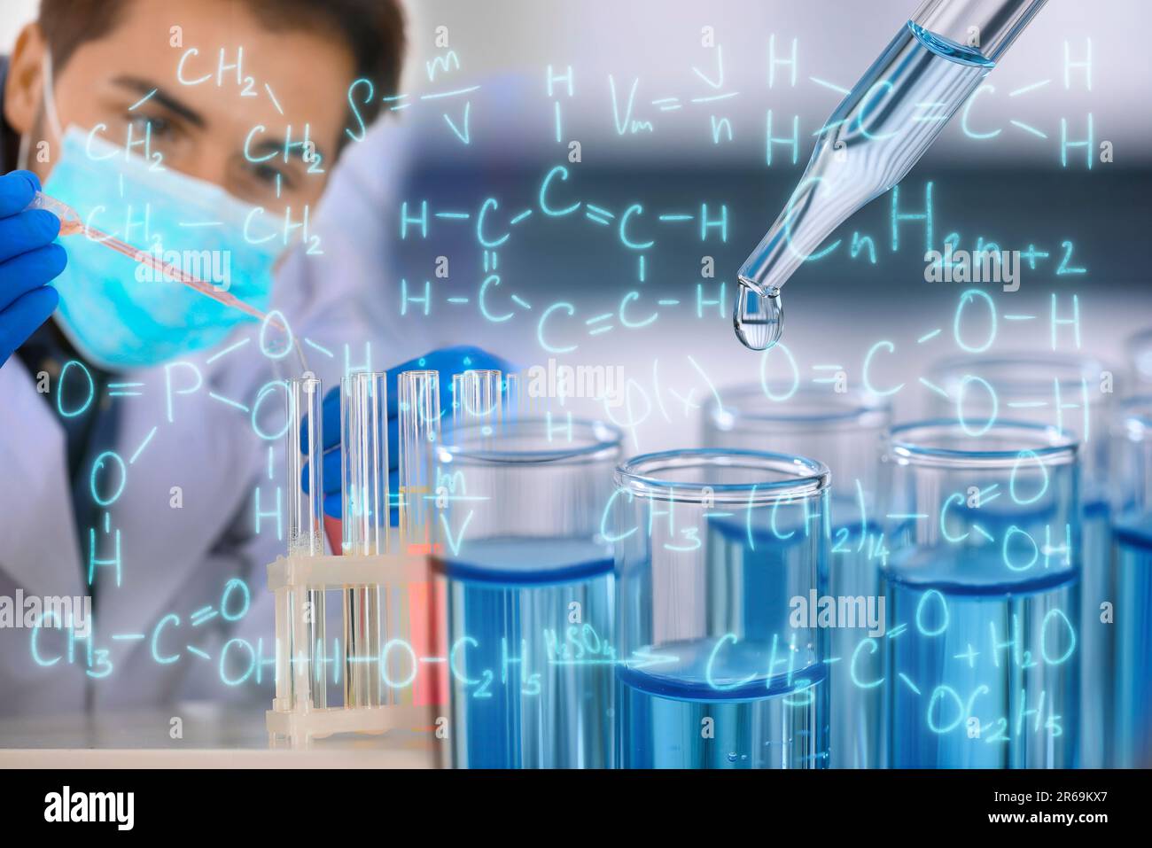 Scientist working in laboratory, dripping reagent into test tube and