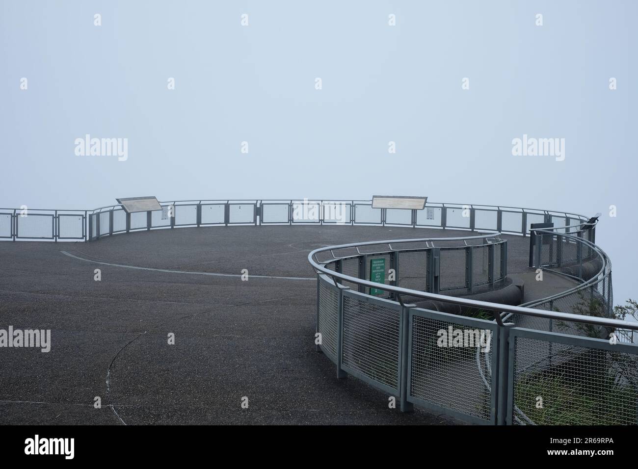 Echo Point, Blue Mountains lookout in a deep fog white-out. Only the railings and panorama view plaques describe the invisible scenery. Katoomba NSW. Stock Photo
