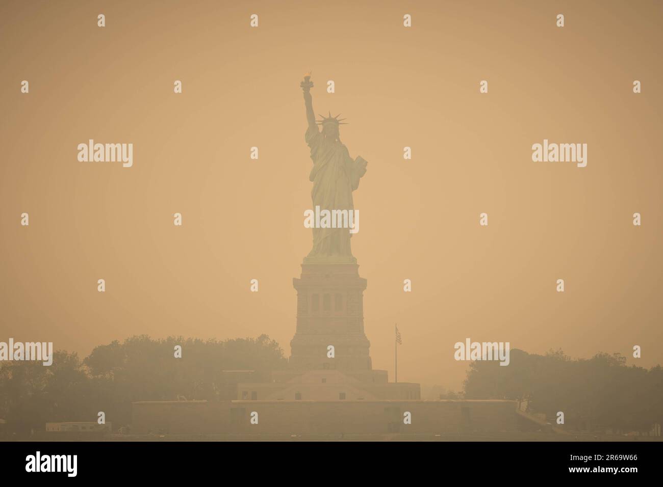 New York, New York, USA. 7th June, 2023. The Statue of Liberty shrouded in smoke from Canada wildfires in New York. The US Northeast, including New York City, will continue to breathe in choking smoke from fires across eastern Canada for the next few days, raising health alarms across impacted areas. (Credit Image: © William Volcov/ZUMA Press Wire) EDITORIAL USAGE ONLY! Not for Commercial USAGE! Stock Photo