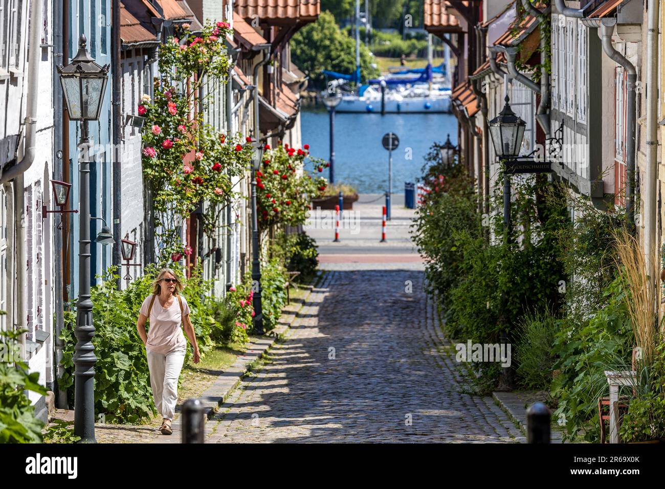 Flensburg, Germany. 07th June, 2023. A woman walks through the Oluf