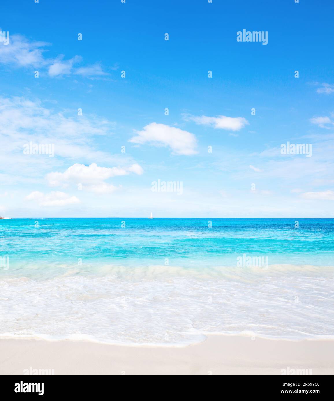 Tropical white sand beach and blue sky at summer sunny day.  Idyllic tropical beach scene. Stock Photo
