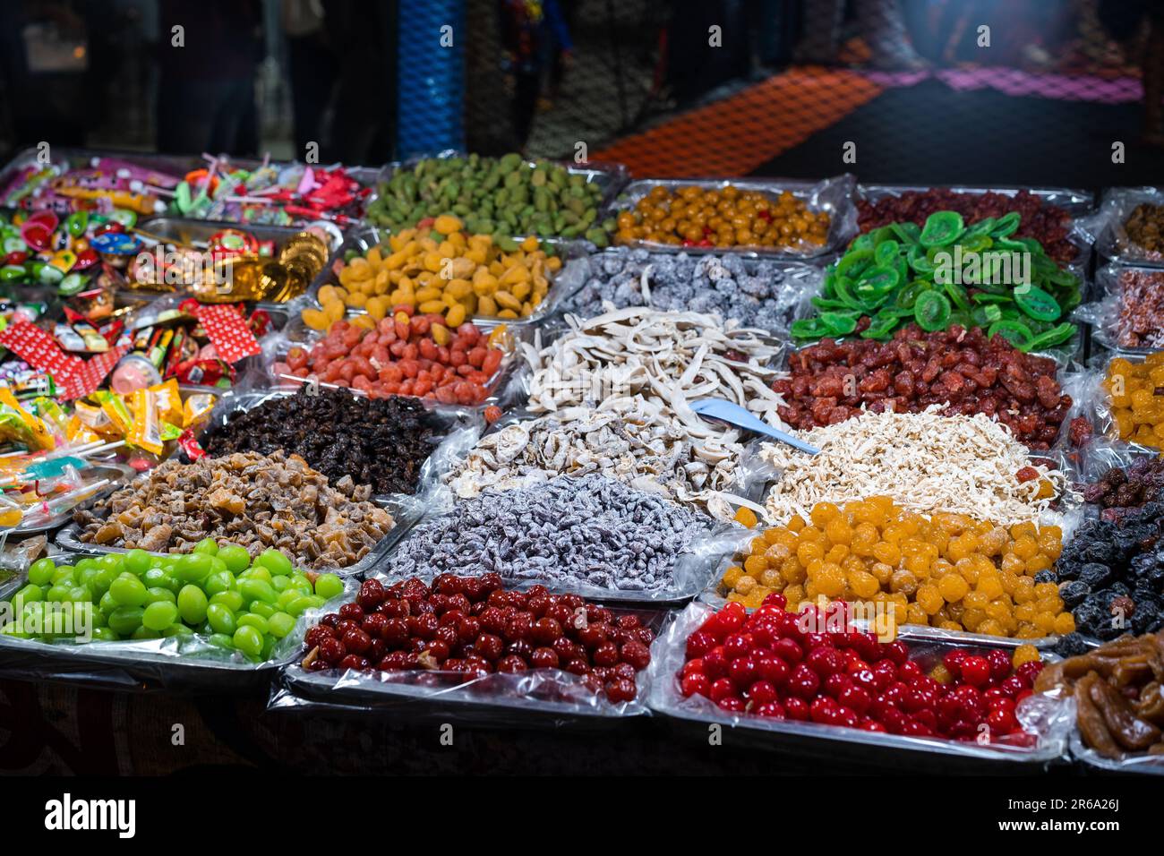 An assortment of brightly colored sweets on display at a night market ...