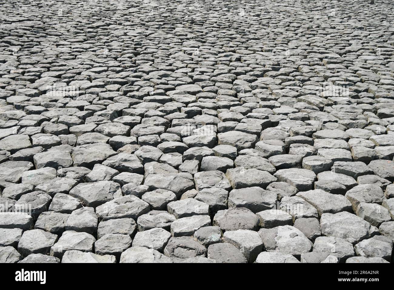 cobblestone background with uneven natural stone paving Stock Photo