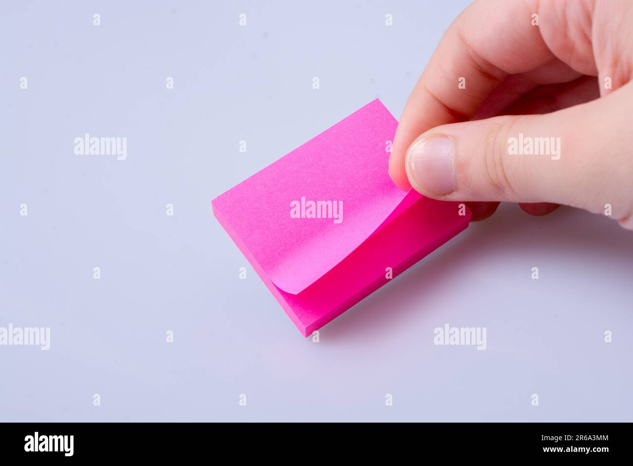 Handing Notes Sticker Post note office sticker for taking notes in hand Stock Photo - Alamy