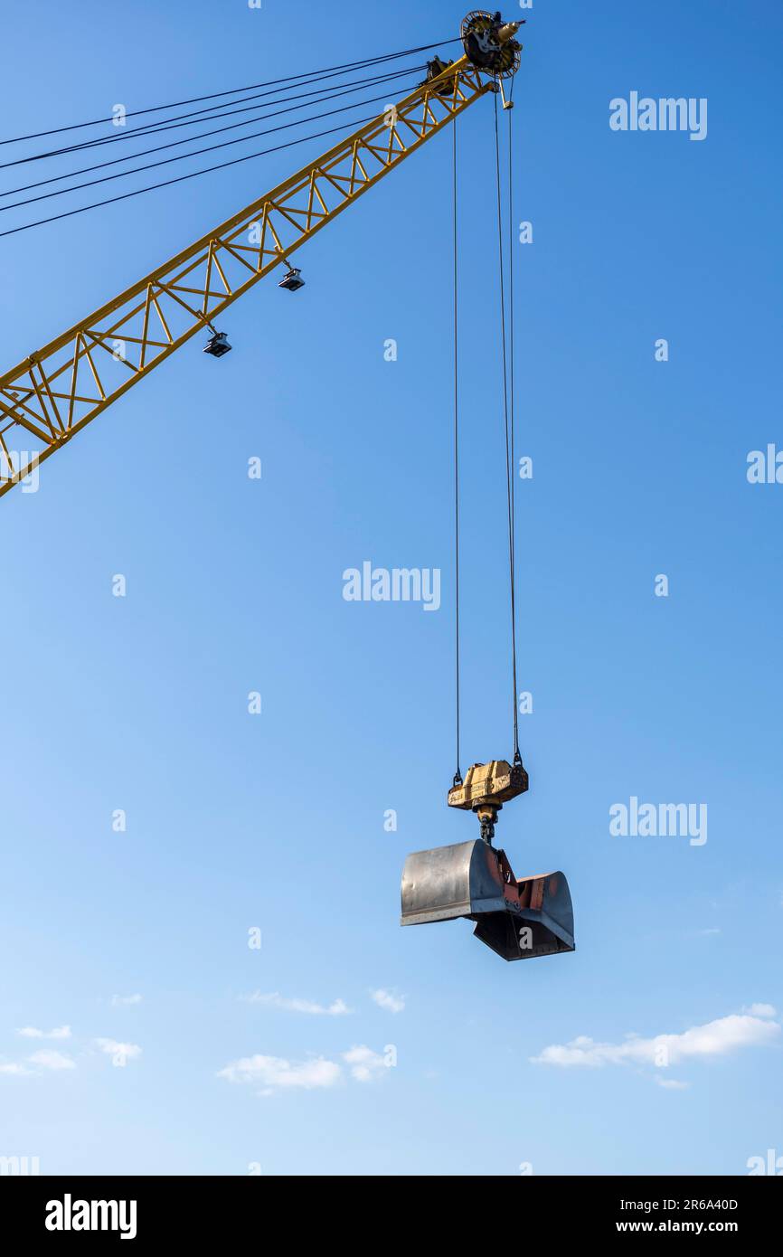 Construction crane with clamshell bucket, bucket Stock Photo
