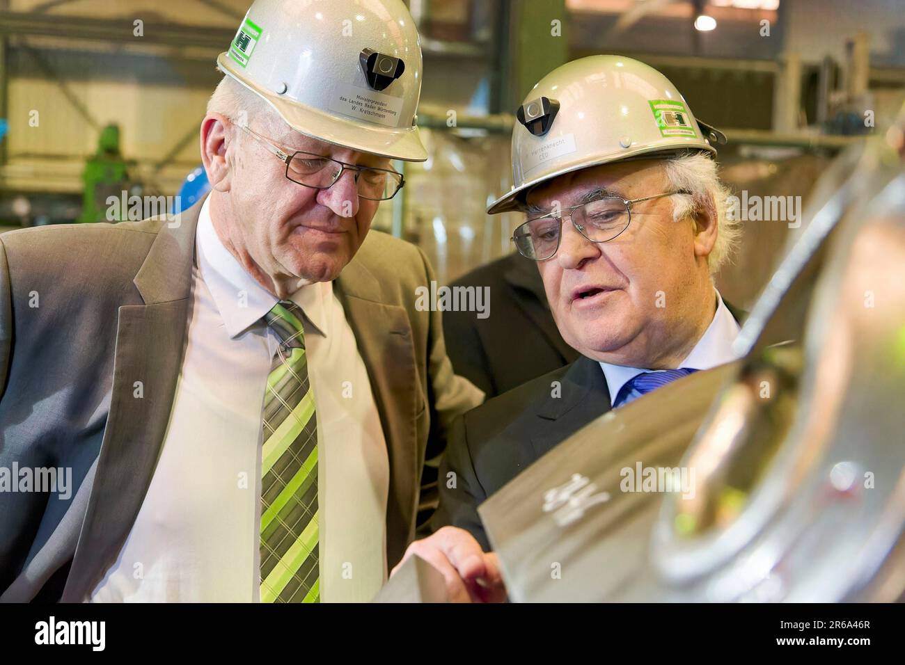 Minister President Winfried Kretschmann with Martin Herrenknecht - both wearing safety helmets - during a visit to Herrenknecht AG. Tunnel, tunnel Stock Photo